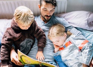 Father children reading book 1200x628 facebook.jpg